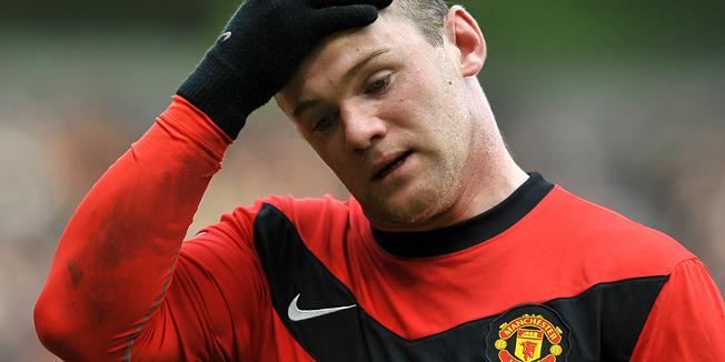 (FILES) In this file picture taken on March 14, 2010 Manchester United's English forward Wayne Rooney reacts during the English Premier League football match against Fulham at Old Trafford in Manchester, north-west England. After being showered with praise for his starring role in the 4-0 Group G rout of Bulgaria, Manchester United icon Rooney awoke on September 5, 2010 to find himself plastered over the tabloid press for all the wrong reasons.The News of the World and Sunday Mirror both carried reports that Rooney had repeatedly frequented a prostitute while wife Coleen was pregnant with their son, prompting speculation about his participation in the key game against Switzerland on September 7, 2010. AFP PHOTO/ANDREW YATES --- RESTRICTED TO EDITORIAL USE Additional licence required for any commercial/promotional use or use on TV or internet (except identical online version of newspaper) of Premier League/Football League photos. Tel DataCo +44 207 2981656. Do not alter/modify photo