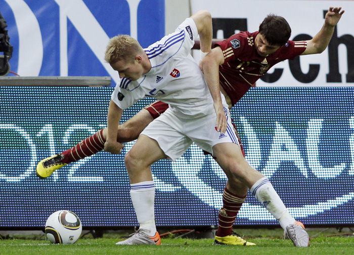 Slovakia's Radoslav Zabavnik, front, and Russia's Alan Dzagoev fight for the ball during their Euro 2012 Group B qualifying soccer match at Lokomotiv stadium in Moscow, Russia, on Tuesday, Sept. 7, 2010. (AP Photo/Ivan Sekretarev)