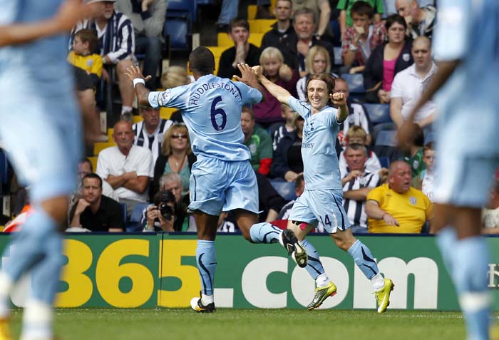 Tottenham Hotspur's Croatian midfielder Luka Modric (R) celebrates scoring the opening goal of the English Premier League football match between West Bromwich Albion and Tottenham Hotspur at The Hawthorns in West Bromwich, West Midlands, England on September 11, 2010. AFP PHOTO/IAN KINGTONFOR EDITORIAL USE ONLY Additional licence required for any commercial/promotional use or use on TV or internet (except identical online version of newspaper) of Premier League/Football League photos. Tel DataCo +44 207 2981656. Do not alter/modify photo.