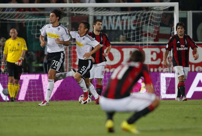 Cesena's Erjon Bogdani (2nd L, number 70) celebrates with teammate Yuko Nagatomo of Japan (centre L, number 5) after scoring against AC Milan during their Italian Serie A football match at the Dino Manuzzi Stadium in Cesena, Italy on September 11, 2010.AFP PHOTO / FABIO MUZZI