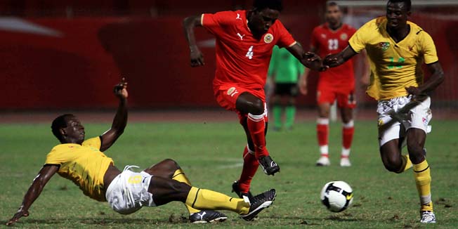 FILE - In this Nov. 6, 2009 file photo, Bahrain's Abdulla Fatadi, center, fights for the ball with Togo's Sadate Akoriko, right, and Abass Zangaba, left, during a friendly soccer match in Riffa, Bahrain. The Togo team that lost 3-0 to Bahrain in an international friendly last week was 