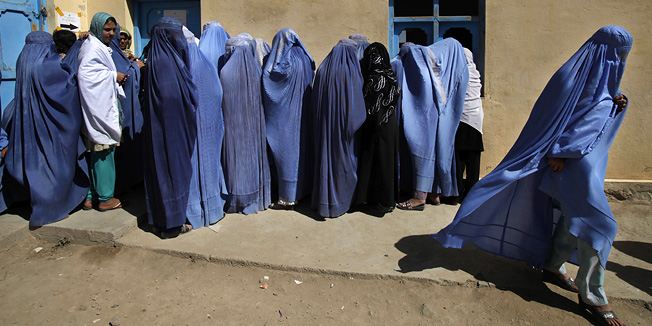 A woman leaves after casting her vote during the pariament elections in Kabul, Afghanistan, Saturday, Sept. 18, 2010. (AP Photo/Saurabh Das)