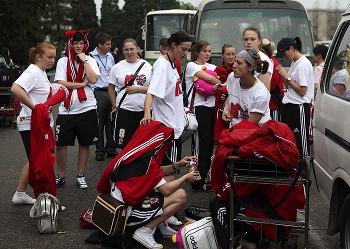 Players from Britain's Middlesbrough Ladies football team wait to get on buses after their arrival at Pyongyang airport, in Pyongyang,  North Korea, Saturday, Sept. 18, 2010.  The team arrived in North Korea for a five-day visit which will include two friendly matches against North Korean teams. (AP Photo/APTN)