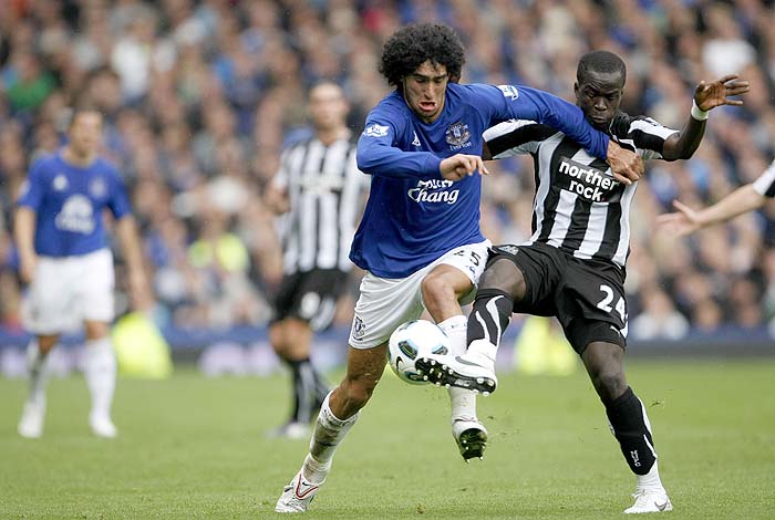 Everton's Marouane Fellaini, second right, vies for the ball against Newcastle's Cheik Tiote during their English Premier League soccer match at Goodison Park, Liverpool, England, Saturday Sept. 18, 2010. (AP Photo/Tim Hales) ** NO INTERNET/MOBILE USAGE WITHOUT FOOTBALL ASSOCIATION PREMIER LEAGUE (FAPL) LICENCE. CALL +44 (0) 20 7864 9121 or EMAIL info@football-dataco.com FOR DETAILS **