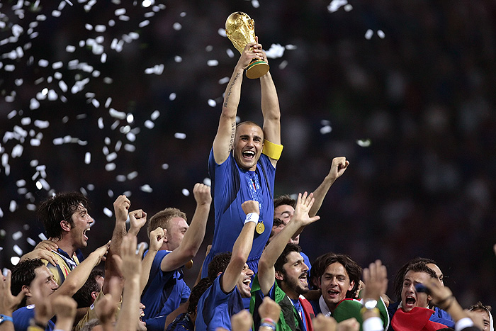 *** THE DECADE IN PICTURES ***Italian defender Fabio Cannavaro (C) celebrates with the trophy after the World Cup 2006 final football game Italy vs.France, 09 July 2006 at Berlin stadium. Italy won the 2006 football World Cup by defeating France on penalties. AFP PHOTO PASCAL PAVANI