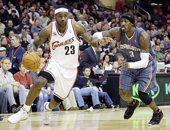 Cleveland Cavaliers forward LeBron James drives around Charlotte Bobcats' Gerald Wallace during the first quarter in a NBA basketball game Sunday, Jan. 3, 2010, in Cleveland. The Bobcats won 91-88. (AP Photo/Ron Schwane)