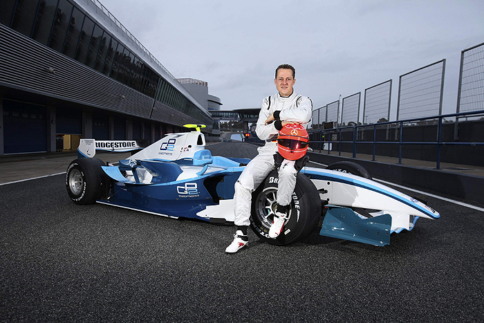 Formula One seven times world champion Michael Schumacher of Germany poses on a GP2 car during a test drive at Jerez circuit in southern Spain, January 12, 2010. Schumacher set his Formula One comeback rolling on Tuesday with a test of a GP2 development car. The 41-year-old German, returning with Mercedes after retiring as a Ferrari driver in 2006, completed 52 laps before heavy rain and gusty conditions halted the session in the afternoon. REUTERS/Malcolm Griffitths/GP2 Media/Handout (SPAIN - Tags: SPORT MOTOR RACING) FOR EDITORIAL USE ONLY. NOT FOR SALE FOR MARKETING OR ADVERTISING CAMPAIGNS