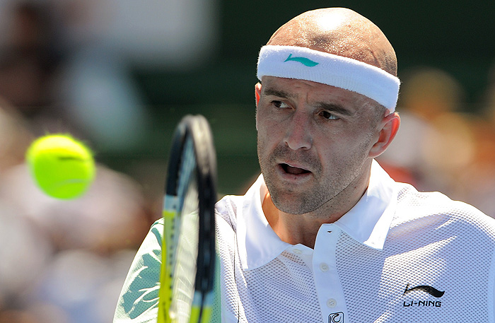 Ivan Ljubicic of Croatia hits a backhand return in his victory over Robin Soldering of Sweden at the Kooyong Classic tennis tournament in Melbourne on January 14, 2010.  Ljubicic won the match 6-1 when Soldering retired injured in the round-robin tournament that is used by top male players as a warm-up to the Australian Open played January 18-31.  AFP PHOTO/William WEST