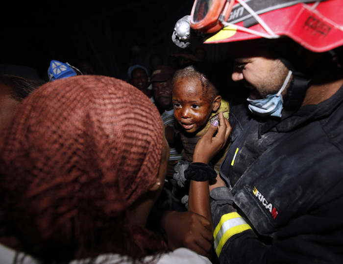 Two year old Redjeson Hausteen Claude reacts to his mother Daphnee Plaisin, after he is rescued from a collapsed home by Belgian and Spanish rescuers  in the aftermath of the powerful earthquake in Port-au-Prince, Thursday, Jan. 14, 2010. A 7.0-magnitude earthquake struck Haiti Tuesday. (AP Photo/Gerald Herbert) Reginald Claude