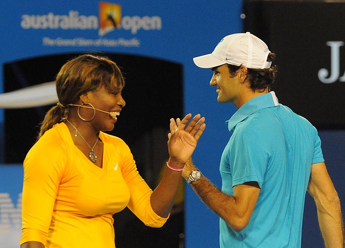 US tennis player Serena Williams (L) shares a light moment with Swiss Roger Federer during a charity tennis exhibition Federer organised for the victims of the Haiti earthquake, a day before the start of the Australian Open tennis tournament in Melbourne on January 17, 2010. At least 50,000 people have been killed and 1.5 million left homeless in the Caribbean nation and Federer said he wanted to do something to help. The Australian Open will take place on January 18-31.    AFP PHOTO/Paul CROCK