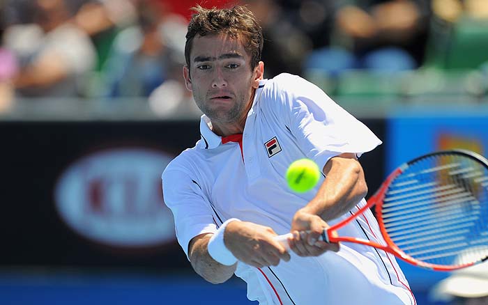 Marin Cilic of Croatia hits a return against Fabrice Santoro of France during their men's singles first round match on day two of the Australian Open tennis tournament in Melbourne on January 19, 2010.  Cilic won 7-5, 7-5, 6-3. The first Grand Slam of the 2010 tennis season is taking place in the Australian city January 18-31.      AFP PHOTO / WILLIAM WEST