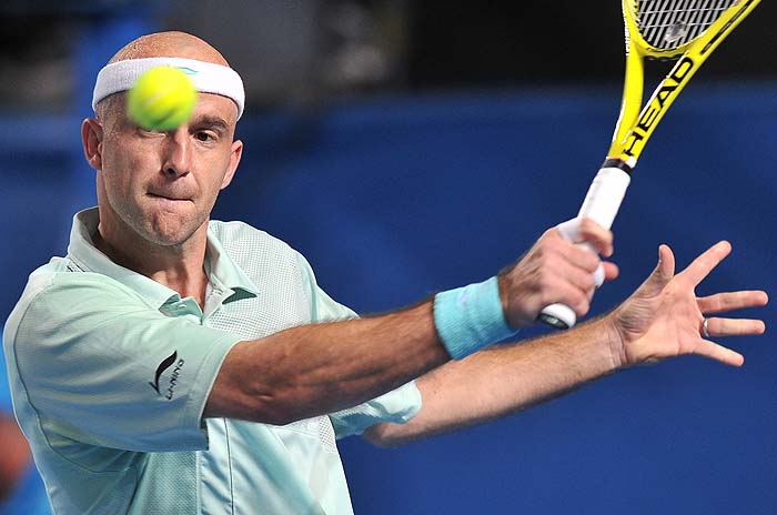 Croatian tennis player Ivan Ljubicic plays a backhand return during his men's singles match against compatriot Ivo Karlovic on the fifth day of play at the Australian Open tennis tournament in Melbourne on January 22, 2010.   The Australian Open is taking place from January 18-31.   AFP PHOTO/Paul CROCK