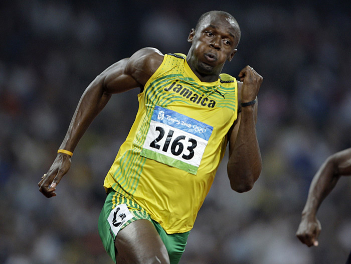 FILE - This is an Aug. 19, 2009, file photo showing Jamaica's Usain Bolt competing in a men's 200-meter semi-final during the athletics competition at the Beijing 2008 Olympics in Beijing. In the short span of two years, Bolt has done a decade's worth of restructuring to track and field's record book. He has made himself a candidate for The Associated Press' Athlete of the Decade by making people rethink what's possible in one of the most basic measures of athleticism: how fast a human can get from Point A to Point B. (AP Photo/David Guttenfelder, File)