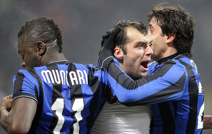 Inter Milan's Macedonian forward Goran Pandev (C)  jubilates with teammates Inter Milan's Ghanaian midfielder Sulley Ali Muntari (L) and Inter Milan's Argentinian forward Alberto Milito Diego (R)  after scoring during the Italian Serie A football match Inter Milan against A.C. Milan on January 24, 2010 at San Siro Stadium in Milan. AFP PHOTO DAMIEN MEYER