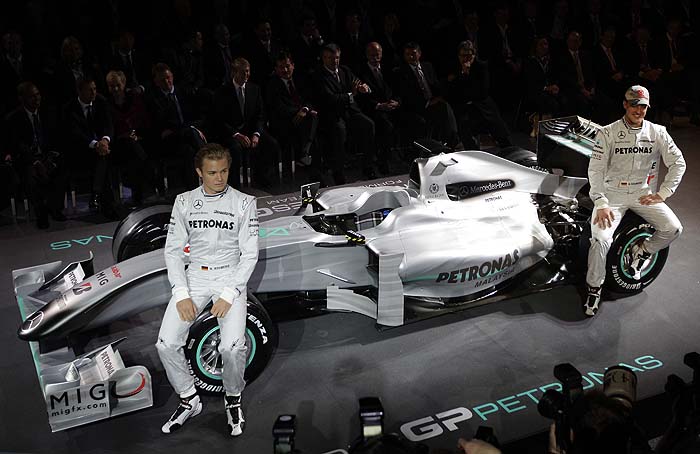 German drivers Nico Rosberg (L) and seven time World Champion Michael Schumacher (R) pose next to a Mercedes GP Formula One race car during the team presentation at the Mercedes museum in Stuttgart, January 25, 2010.  REUTERS/Kai Pfaffenbach (GERMANY - Tags: SPORT MOTOR RACING)