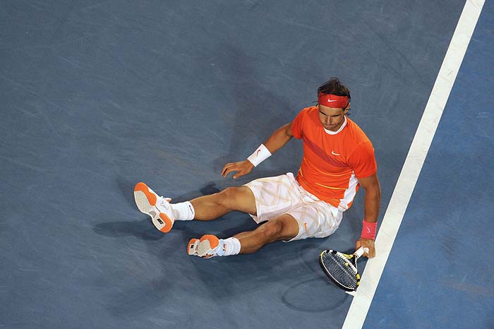 Spanish tennis player Rafael Nadal lies on court during his men's singles quarter-final match against British opponent Andy Murray on day nine at the Australian Open tennis tournament in Melbourne on January 26, 2010.   British fifth seed Andy Murray moved into the Australian Open semi-finals when defending champion Rafael Nadal retired when trailing 6-3, 7-6 (7/2), 3-0.  AFP PHOTO/Torsten BLACKWOOD