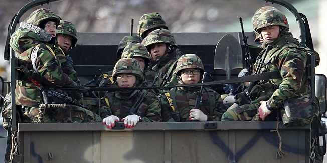 South Korean marines ride on the back of a truck on Yeonpyeong Island, South Korea, Monday, Dec. 6, 2010. South Korea is conducting naval firing drills just a day after North Korea warned such exercises would aggravate already high tensions between the rivals. (AP Photo/Yonhap, Kim hyun-tae)  KOREA OUT