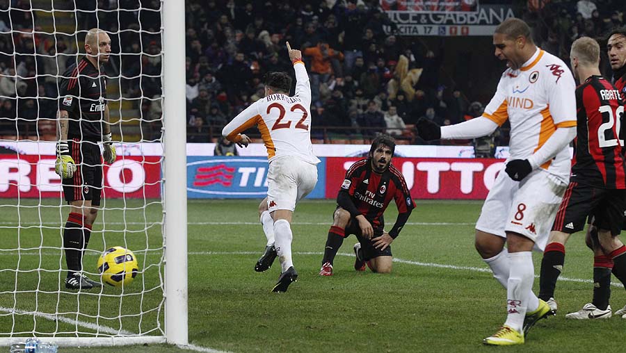 AS Roma forward Marco Borriello, center, back to camera, celebrates after scoring during a Serie A soccer match between AC Milan and Roma at the San Siro stadium in Milan, Italy, Saturday Dec. 18, 2010. At right is seen AS Roma Brazilian forward Adriano. (AP Photo/Luca Bruno)