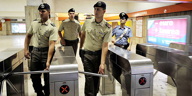 (FILES) A picture taken on August 4, 2008 shows Italian soldiers patrolling with Italian Carabinieri at a metro station in Rome. A parcel bomb was found by transport workers in an empty train carriage in Rome's metro system and defused on December 21, 2010 a spokesman for the city council told AFP.  