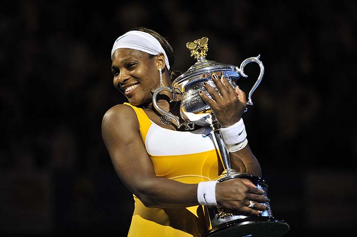 US tennis player Serena Williams poses with the trophy after victory in her women's singles final match against Belgian opponent Justine Henin at the Australian Open tennis tournament in Melbourne on January 30, 2010.  Williams won 6-4. 3-6. 6-2.      AFP PHOTO/Paul CROCK