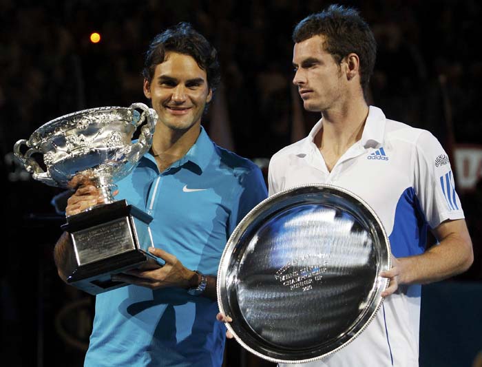 Roger Federer of Switzerland and Britain's Andy Murray pose with their trophys at the conclusion of the men's singles final at the Australian Open tennis tournament in Melbourne January 31, 2010. REUTERS/Daniel Munoz  (AUSTRALIA - Tags: SPORT TENNIS)