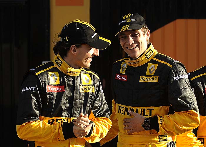 Renault Polish driver Robert Kubica (L) and Russian driver Vitaly Petrof pose during the presentation of the new Renault F30 Formula 1 racing car at the Ricardo Tormo racetrake in Cheste, near Valencia, on January 31 2010.   AFP PHOTO / PEDRO ARMESTRE