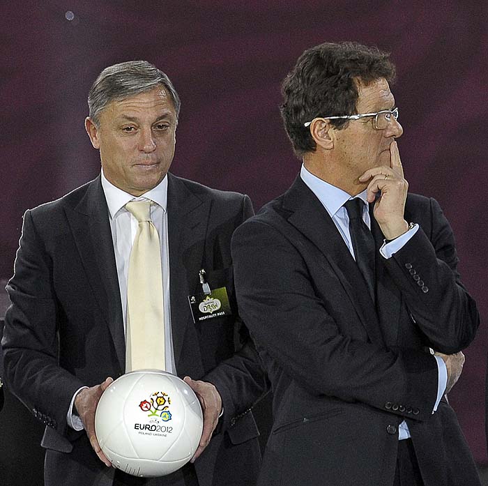 Coaches of group G, Montenegro Zlatko Kranjcar (holding an official Euro 2012 ball) and England Fabio Capello stand on the stage after the Euro 2012 football championship qualifying draw ceremony in Warsaw on February 7, 2010. The qualifying campaign for the 2012 European soccer championships, that will be jointly hosted by Poland and Ukraine, gets underway in September 2010. AFP PHOTO / JANEK SKARZYNSKI