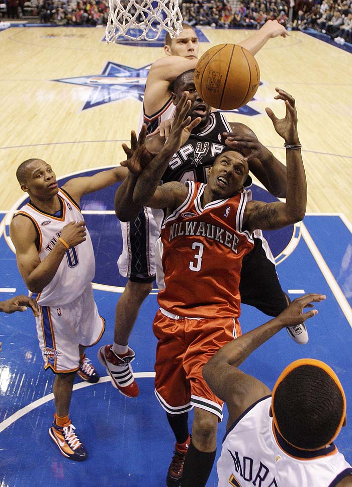 Sophomore Team member and Oklahoma City Thunder Russell Westbrook (L) and Golden State Warriors Anthony Morrow (Bottom R) look on as Rookie Team Member and Milwaukee Bucks Brandon Jennings (C Bottom) goes up for a shot in front of Rookie Team Member and San Antonio Spurs player DeJuan Blair (C) and Sophomore Team member and Minnesota Timberwolves Brook Lopez (Top) compete for the ball during the NBA All-Star Rookie Challenge in Dallas, Texas February 12, 2010. REUTERS/Eric Gay/Pool (UNITED STATES - Tags: SPORT BASKETBALL)