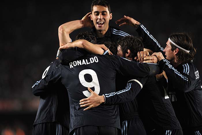 Real Madrid's Portuguese forward Cristiano Ronaldo (centre) celebrates after scoring against Xerez during a Spanish league football match at Chapin stadium in Jerez, on February 13, 2010.AFP PHOTO / CRISTINA QUICLER