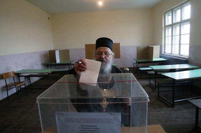 (FILES) In this file picture taken on January 20, 2008 Kosovo Archbishop Artemije of Raska and Prizren casts his vote at a polling station in the village of Gracanica.  The Serbian Orthodox Church has temporarily suspended its top bishop in Kosovo for allegedly embezzling church and state funds in the breakaway territory, a statement said on February 13, 2010. The Holy Synod decided that archbishop Artemije would be 