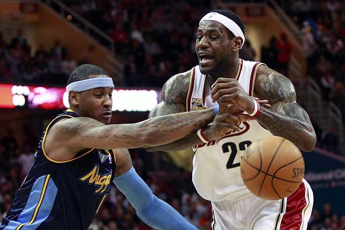 Cleveland Cavaliers LeBron James (R) has the ball knocked away by Denver Nuggets Carmelo Anthony during the first quarter of their NBA basketball game in Cleveland, February 18, 2010. REUTERS/Aaron Josefczyk (UNITED STATES - Tags: SPORT BASKETBALL)