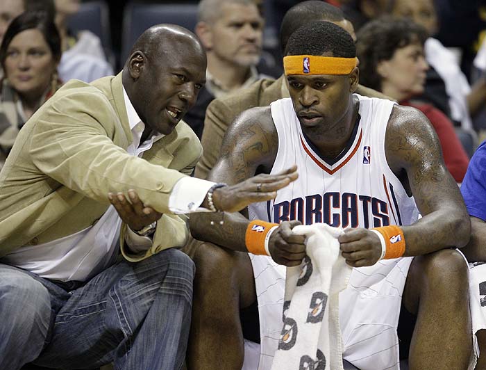 Charlotte Bobcats managing partner Michael Jordan, left, talks with Bobcats' Stephen Jackson in the first half of an NBA basketball game against the Memphis Grizzlies in Charlotte, N.C., Saturday, Jan. 9, 2010. (AP Photo/Chuck Burton)