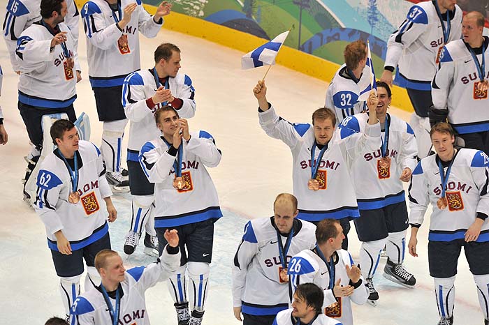 The Finish team wear their bronze medals as they celebrate following their win over Slovakia in the Men's Bronze Medal Hockey game at the Canada Hockey Place during the XXI Winter Olympic Games in Vancouver, Canada on February 27, 2010. Finland won 5-3 against Slovakia to snatch the Olympic bronze.  AFP PHOTO / CRIS BOURONCLE