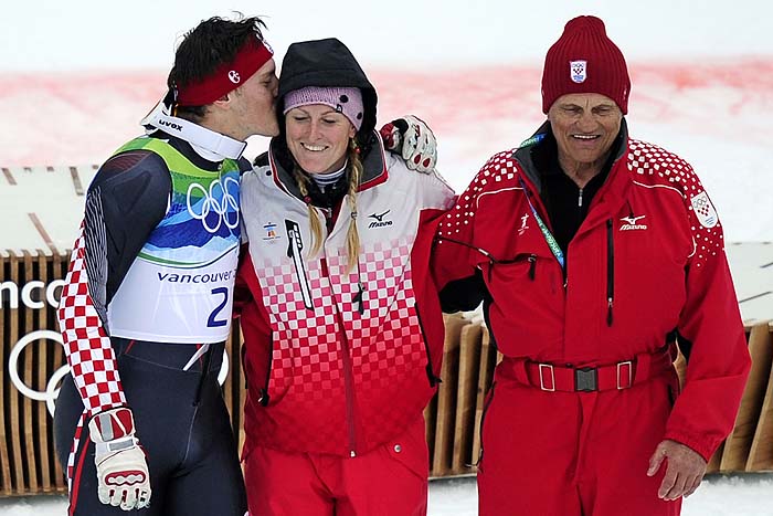 Croatia's silver medalist Ivica Kostelic (L) kisses his sister Janica Kostelic as their father Ante Kostelic (R) smiles on the podium after the flower ceremony of the men's slalom race of the Vancouver 2010 Winter Olympics at the Whistler Creek side Alpine skiing venue on February 27, 2010. AFP PHOTO OLIVIER MORIN