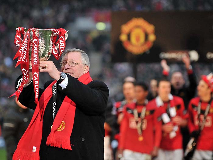 Manchester United manager Sir Alex Ferguson celebrates with the trophy after his team beat Aston Villa 2-1 to win the 2010 Carling Cup Final at Wembley, in north London, on February 28, 2010. AFP PHOTO/CARL DE SOUZA