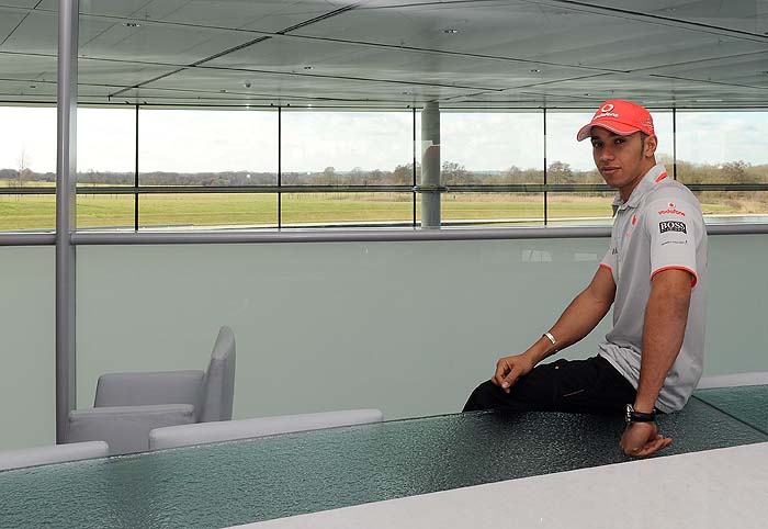 Formula One motor racing driver Lewis Hamilton of Britain poses for photographs following a Reuters television interview at the McLaren team headquarters near Woking in southern England March 1, 2010. The 2010 F1 season starts on March 14 in Bahrain. REUTERS/Toby Melville (BRITAIN - Tags: SPORT MOTOR RACING)