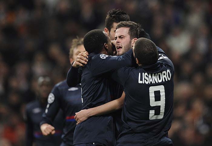 Olympique Lyon's Bosnian midfielder Miralem Pjanic (C) celebrates with teammates after scoring against Real Madrid during their UEFA Champions League football match at the Santiago Bernabeu stadium in Madrid, on March 10, 2010. AFP PHOTO / PIERRE-PHILIPPE MARCOU