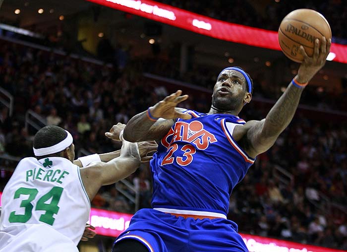 Cleveland Cavaliers LeBron James (23) reaches out to put a shot up past Paul Pierce of the Boston Celtics during the fourth quarter of their NBA basketball game in Cleveland, March 14, 2010. REUTERS/Aaron Josefczyk (UNITED STATES - Tags: SPORT BASKETBALL)
