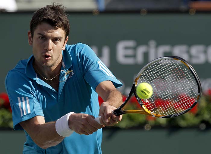 Mario Ancic, of Croatia, hits to Rafael Nadal, of Spain, during their match at the BNP Paribas Open tennis tournament in Indian Wells, Calif., Monday, March 15, 2010. (AP Photo/Chris Carlson)