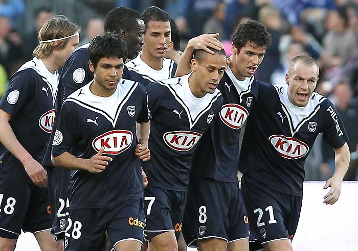 Bordeaux's Yoann Gourcuff, second right, reacts surrouded by his teammates after scoring during their French League one soccer match against Lille in Bordeaux, southwestern France, Sunday March 21, 2010. (AP Photo/Bob Edme)