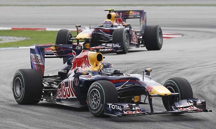 Red Bull Formula One driver Sebastian Vettel, right, of Germany leads teammate Mark Webber of Australia early in the the Malaysian Formula One Grand Prix in Sepang, Malaysia, Sunday, April 4, 2010. (AP Photo/Mark Baker)