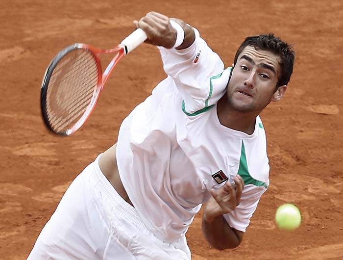 Croatian player Marin Cilic serves to his Russian opponent Igor Andreev during their Monte-Carlo ATP Masters Series Tournament tennis match, on April 13, 2010 in Monaco.  AFP PHOTO VALERY HACHE