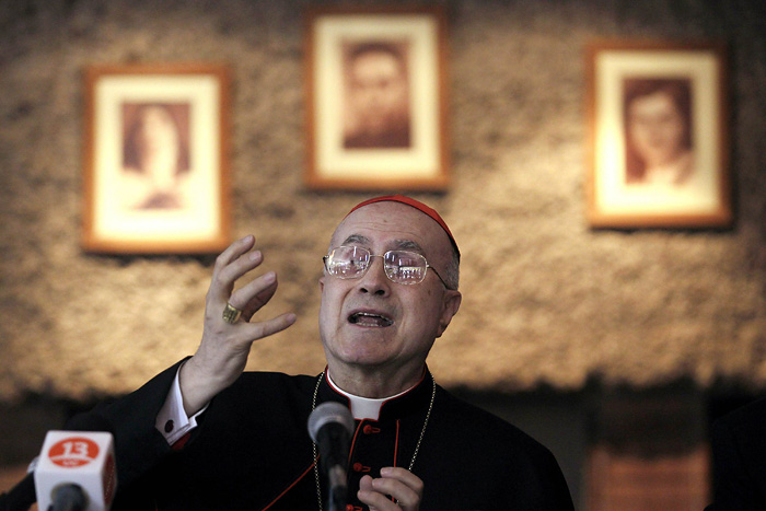 Vatican Secretary of State Cardinal Tarcisio Bertone answers a question during a news conference in Santiago April 12, 2010. Bertone is in Chile as part of an official visit. REUTERS/Ivan Alvarado (CHILE - Tags: POLITICS RELIGION)