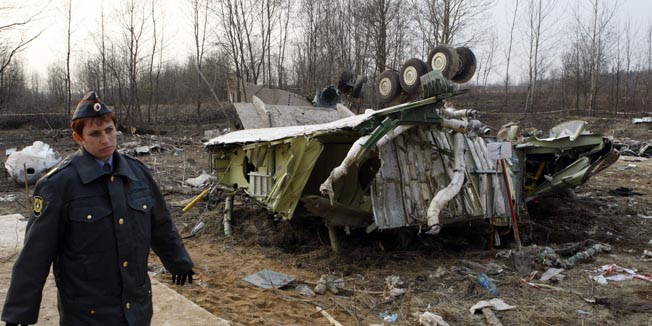 The female policeman secures the site near the wreckage of the Polish presidential plane, that crashed Saturday just outside Smolensk airport, western Russia, Tuesday, April 13, 2010. Polish President Lech Kaczynski, his wife and some of the country's most prominent military and civilian leaders died Saturday along with dozens of others when the presidential plane crashed as it came in for a landing in thick fog near Smolensk in western Russia. (AP Photo/Mikhail Metzel)