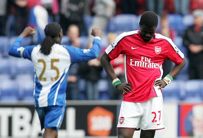 Arsenal's Emmanuel Eboue, right, reacts after losing to Wigan Athletic in their English Premier League soccer match at DW Stadium, Wigan, England, Sunday April 18, 2010. (AP Photo/Tim Hales) ** NO INTERNET/MOBILE USAGE WITHOUT FOOTBALL ASSOCIATION PREMIER LEAGUE (FAPL) LICENCE. CALL +44 (0) 20 7864 9121 or EMAIL info@football-dataco.com FOR DETAILS **