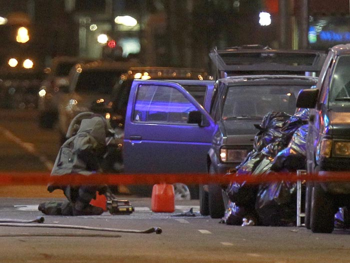 A NYPD officer in an bomb suit examines a Nissan Pathfinder sport utility vehicle parked in New York's Times Square May 1, 2010. An apparent failed car bomb that was smoking and emitted a 