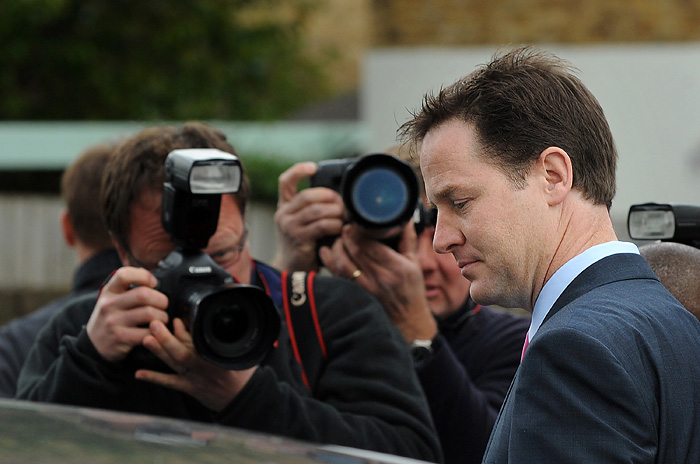 British Liberal Democrat Leader Nick Clegg (R) is surrounded by photographers as he leaves his home in London, on May 11, 2010. Talks on forming a new government in Britain reached 