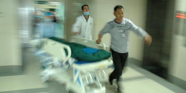 In this photo released by China's Xinhua News Agency, medical workers take an injured child to ICU at 3201 Hospital in Hanzhong City, northwest China's Shaanxi Province Wednesday, May 12, 2010. An attacker hacked seven children and one teacher to death Wednesday and wounded 20 other people in a rampage at a kindergarten in northwest China, the latest in a string of savage assaults at the country's schools. (AP Photo/Xinhua, Wu Tianchang) ** NO SALES **