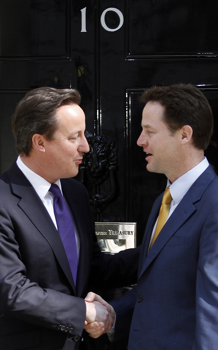 New British Prime Minister David Cameron, left, greets leader of the Liberal Democrats Nick Clegg on the doorstep  of 10 Downing Street  in London, Wednesday, May 12, 2010. British Prime Minister David Cameron has quietly begun his first full day at work, arriving at his new home No. 10 Downing Street but making no immediate announcements about the shape of his government.(AP Photo/Lefteris Pitarakis)
