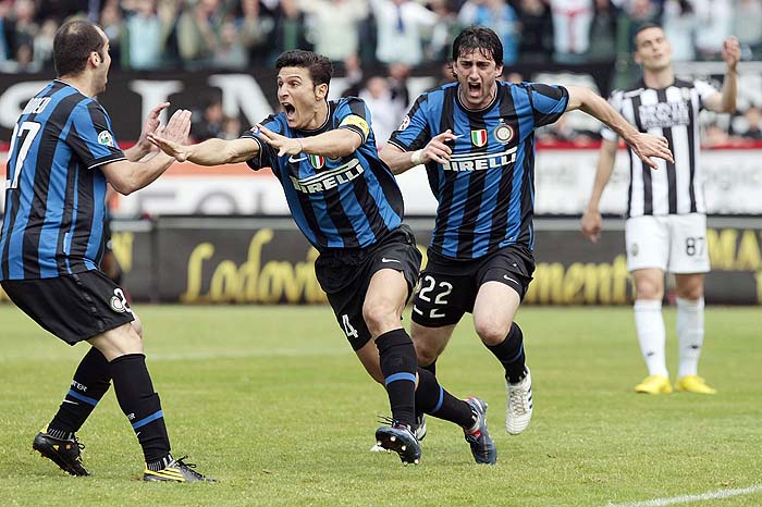 Inter Milan's Argentine striker Diego Milito, right, celebrates with his teammates Javier Zanetti, center, and Goran Pandev after scoring his side 1-0, during the Serie A soccer match between Siena and Inter Milan, in Siena, Italy, Sunday, May 16,  2010. (AP Photo/Gregorio Borgia)
